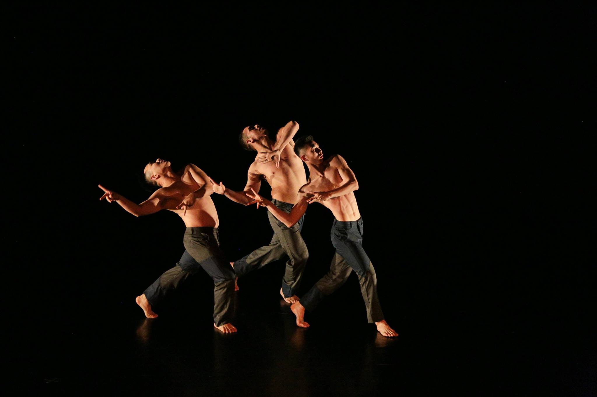 three male dancers on a black background at El Camino College